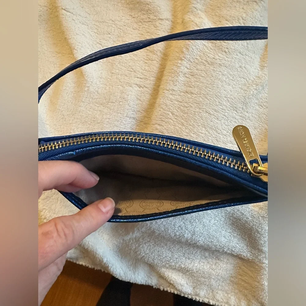 Michael Kors sapphire blue sequined wristlet with gold colored hardware.